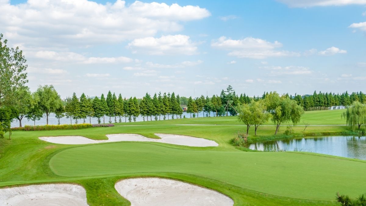 lakeside fairways and white sand bunkers at Vinpearl Golf Nam Hoi An