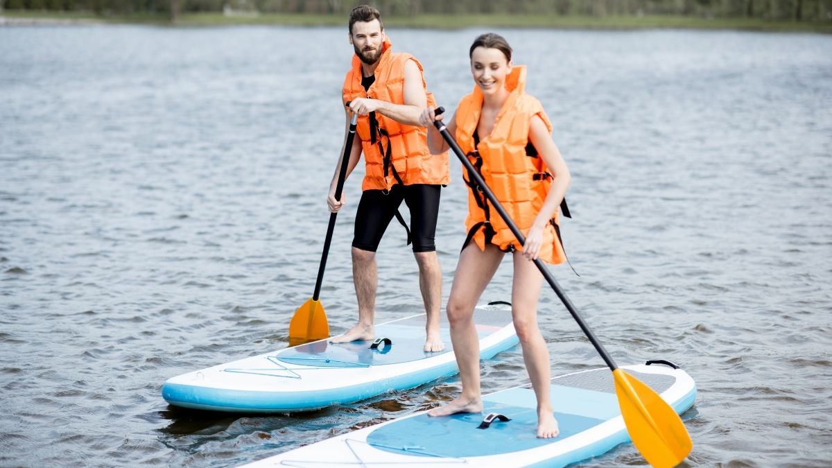 Couple trying Stand Up Paddleboarding at An Bang beach